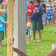 Anita is registered to the contest to win money with this photo: child, children, outdoor, grass, toy, group, people, casual, summer, daylight, clothing, greenery, post, hand, line, waiting, park, footwear, person, event