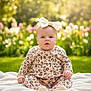 Daisy is registered to the contest to win money with this photo: baby, child, infant, outdoor, garden, grass, blanket, flower, greenery, headband, bow, cute, sitting, portrait, sunlight, nature, soft, clothing, curious, happy