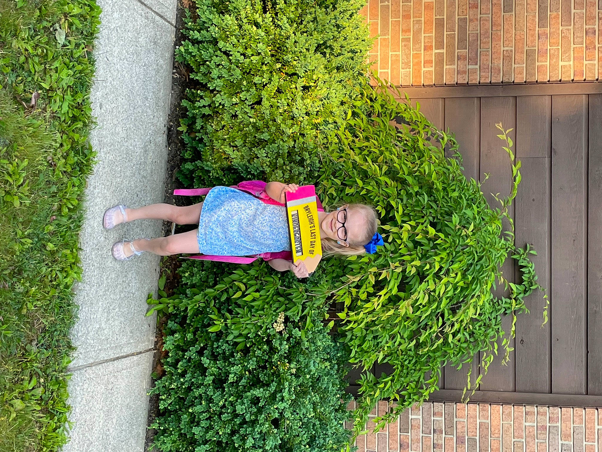 Bryleigh joined the competition — help win amazing prizes! annual_plant, fence, flower, fun, garden, grass, grass_family, groundcover, hat, herb, joy, landscape, landscaping, leisure, people_in_nature, person, plant, shadow, shrub, sidewalk