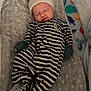 baby, sleeping, infant, crib, blanket, hat, onesie, striped_clothing, pacifier, mittens, footed_pajamas, soft_toys, baby_bedding, indoor, newborn, resting, cute, cozy, child, nursery