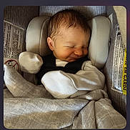 Gabriel is registered to the contest to win money with this photo: newborn, baby, sleeping, car_seat, blanket, mittens, infant, child, cute, cozy, soft, peaceful, indoors, portrait, clothing, head, face, rest, comfort, babycare