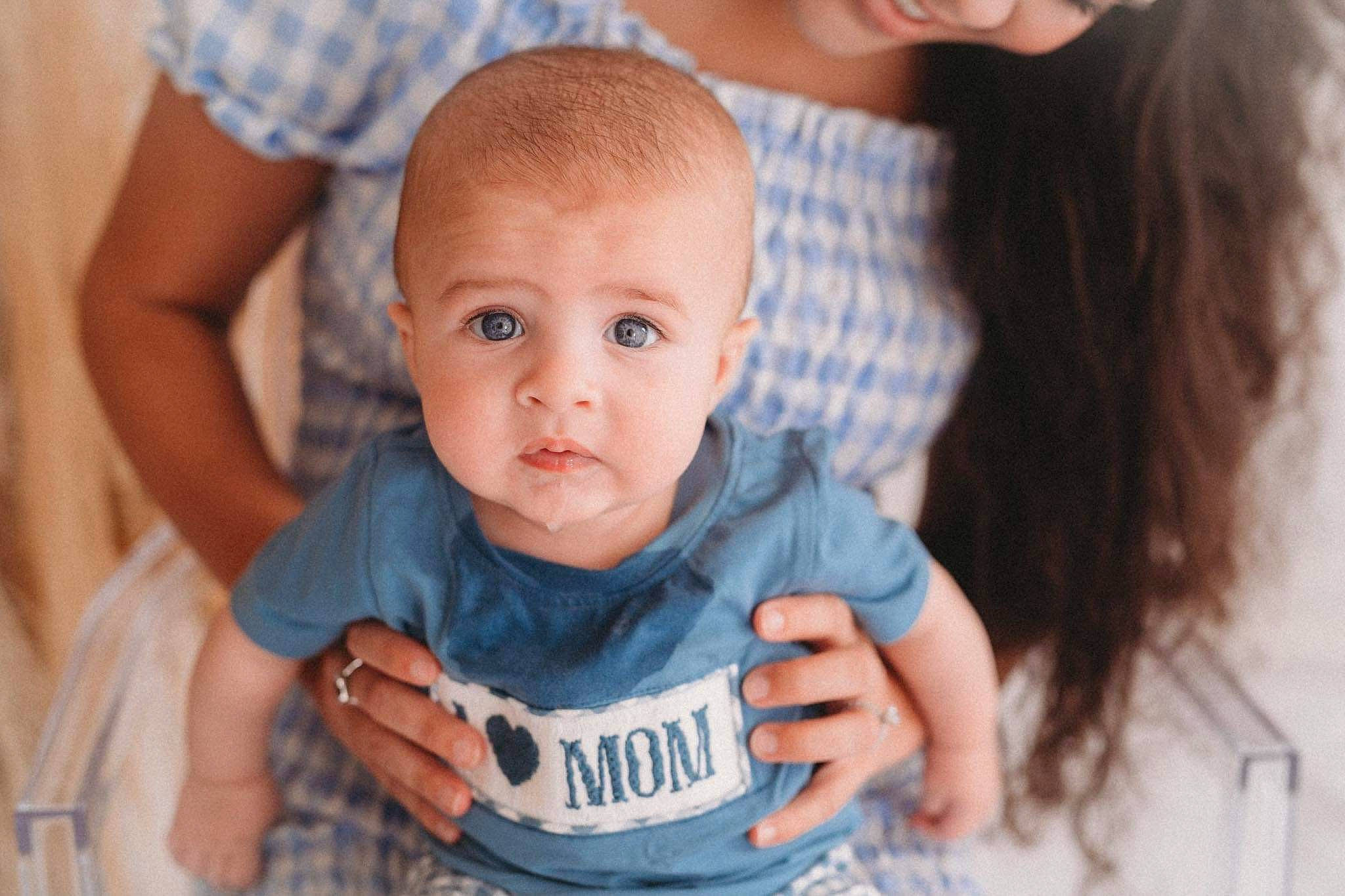 Tate joined the competition — help win amazing prizes! arm, azure, baby, baby_toddler_clothing, cheek, event, finger, fun, gesture, grass, hand, happy, iris, nose, person, plant, sitting, skin, t_shirt, toddler