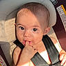 Sophia is registered to the contest to win money with this photo: baby, child, car_seat, safety_harness, fingers, sunlight, shadow, cute, infant, seat, straps, skin, head, face, eyes, expression, indoor, closeup, person, young