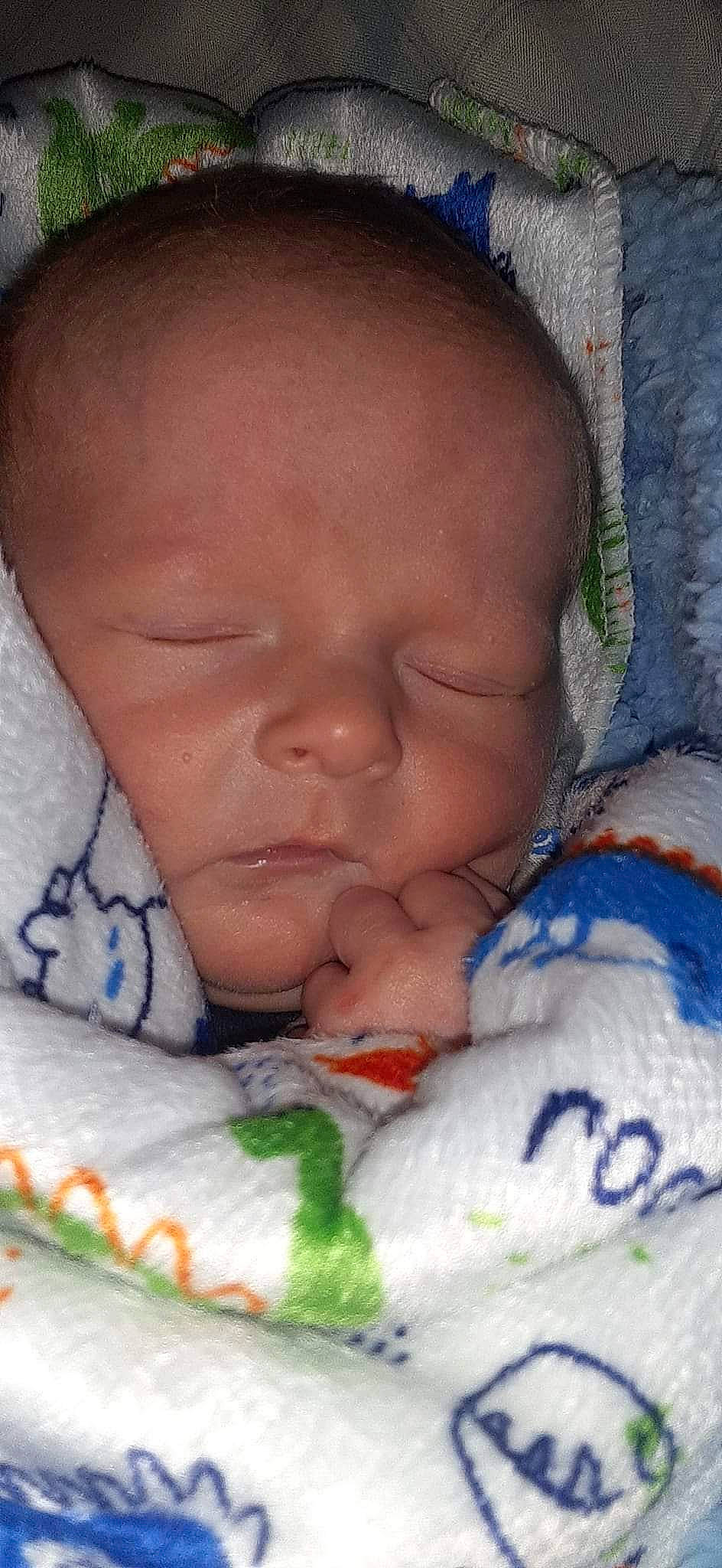 Brady is registered to the contest to win money with this photo: baby, baby_sleeping, cheek, chin, close_up, comfort, eyebrow, face, finger, forehead, hand, happy, linens, lip, mouth, nail, nose, person, skin, thumb