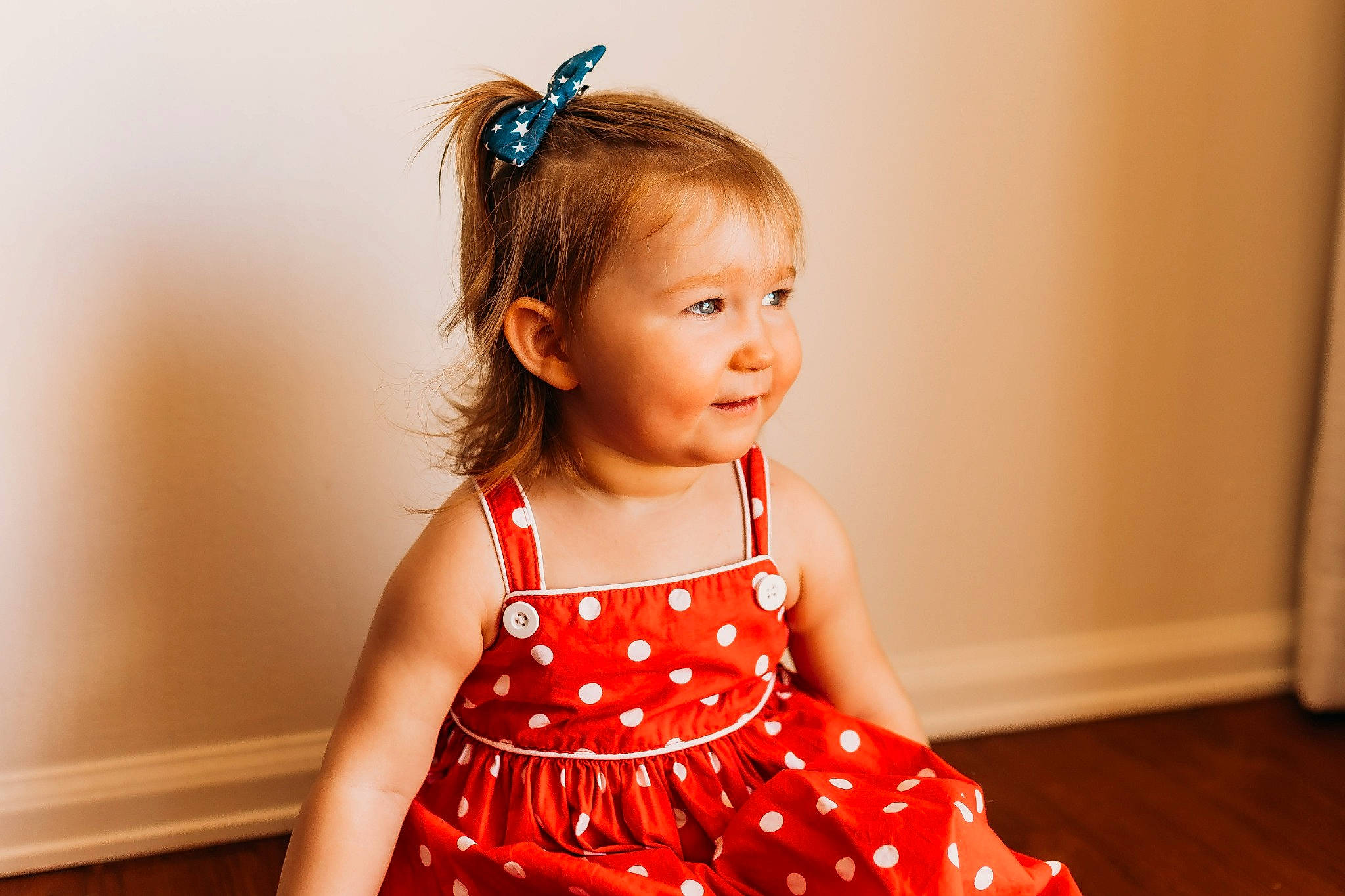 Ella is registered to the contest to win money with this photo: arm, baby_toddler_clothing, blue, child, day_dress, dress, eyelash, face, fun, hairstyle, happy, neck, one_piece_garment, pattern, person, shoulder, skin, sleeve, smile, toddler