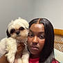 Gucci Bandit joined the competition — help win amazing prizes! chair, cute, dog, fur, hand, indoor, long_hair, looking_at_camera, neutral_expression, nose_ring, person, pet, piercing, pillow, rattan_chair, red_shirt, selfie, small_dog, wall, white_dog