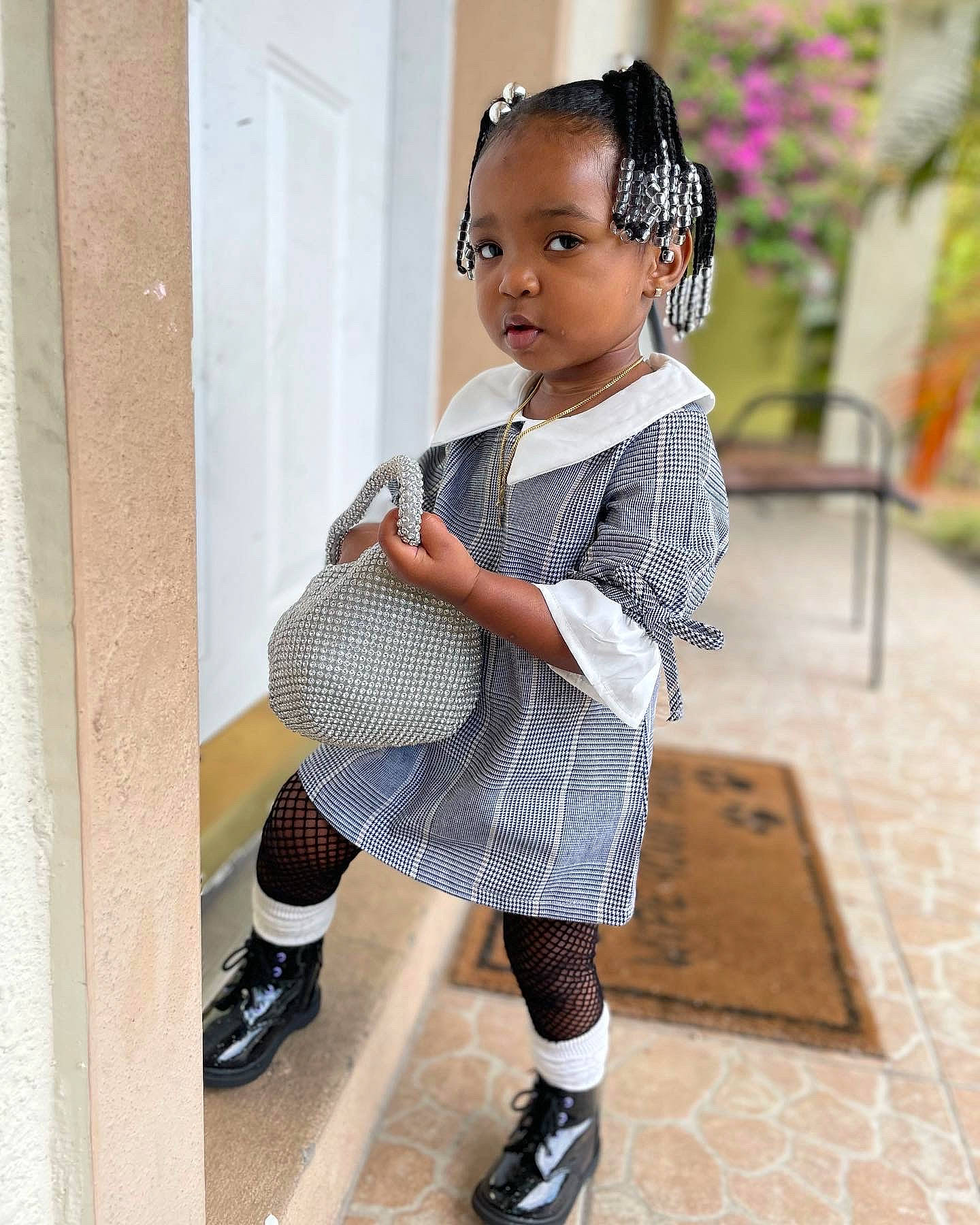 Kylani is registered to the contest to win money with this photo: baby_toddler_clothing, day_dress, face, fashion_design, footwear, human_leg, knee, leg, pattern, person, plaid, shoe, sleeve, sneakers, sock, street_fashion, tartan, thigh, toddler, waist