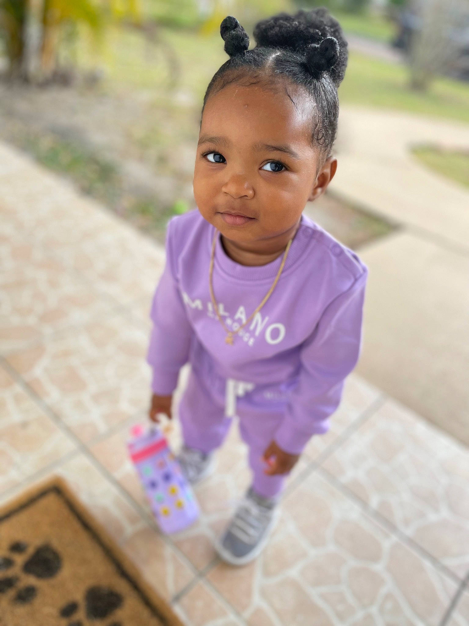 Kylani is registered to the contest to win money with this photo: arm, baby, baby_toddler_clothing, child, dress, flooring, fun, grass, happy, indoor_games_and_sports, leisure, magenta, person, pink, play, purple, recreation, skin, sleeve, smile