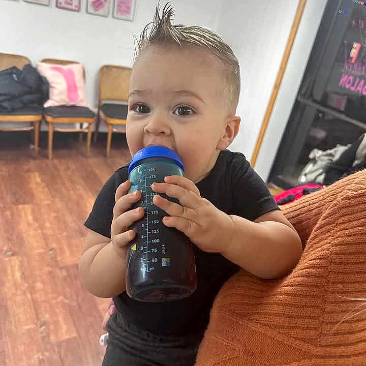 Noah is registered to the contest to win money with this photo: alcohol, beverage, blonde, can, clothing, drinking, drinkingalcohol, eating, face, food, hair, head, karaoke, leisureactivities, person, sitting, sleeve, tin