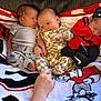 baby, infant, newborn, blanket, cartoon, hand, clothing, red, gray, patterned, sleeping, smiling, cute, indoor, couch, person, face, sitting, soft, cozy