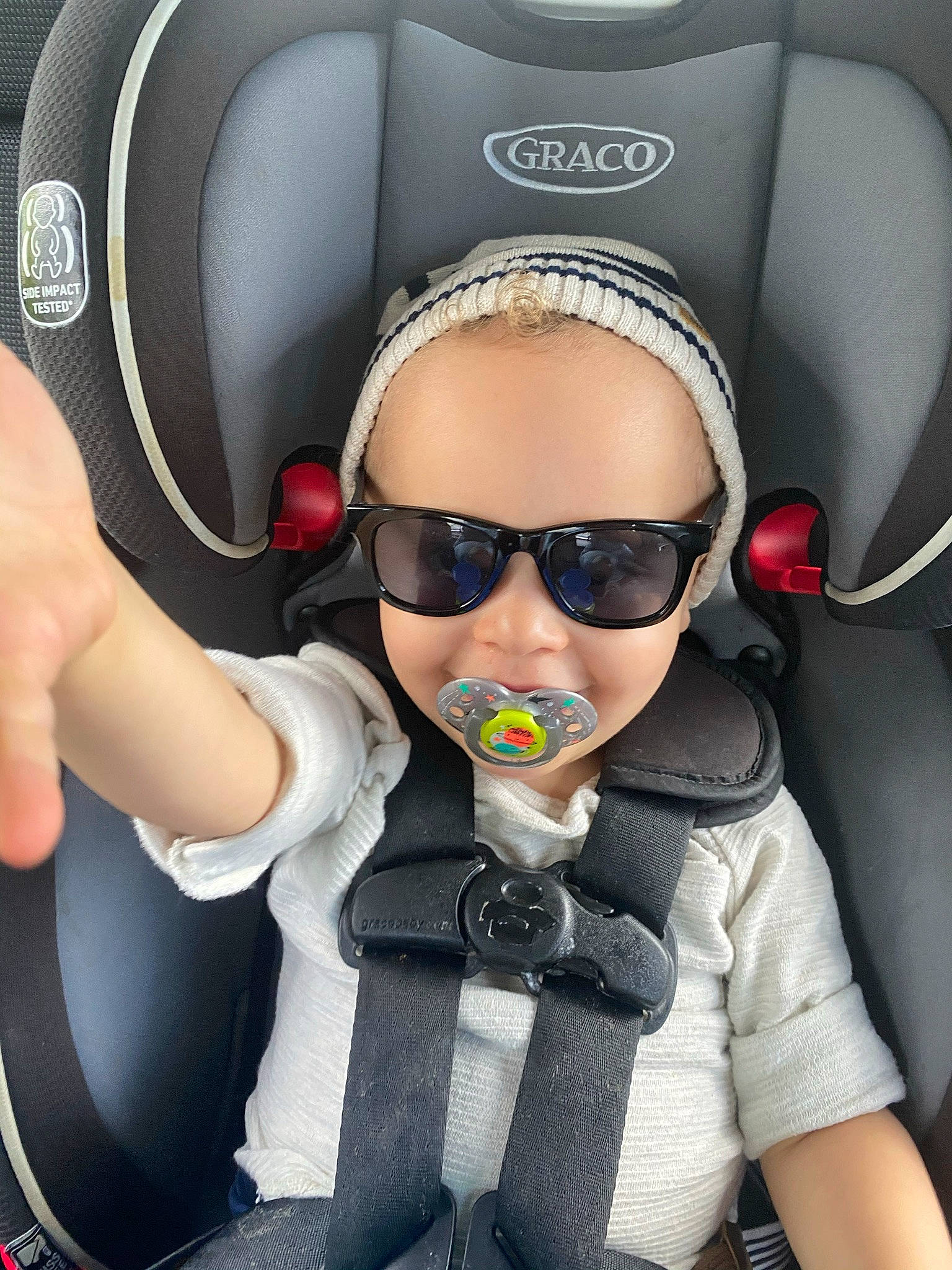 Evan is registered to the contest to win money with this photo: audio_equipment, auto_part, automotive_design, car_seat, car_seat_cover, child, comfort, eyewear, fun, gesture, glasses, goggles, head, head_restraint, person, personal_protective_equipment, seat_belt, service, sunglasses, vision_care