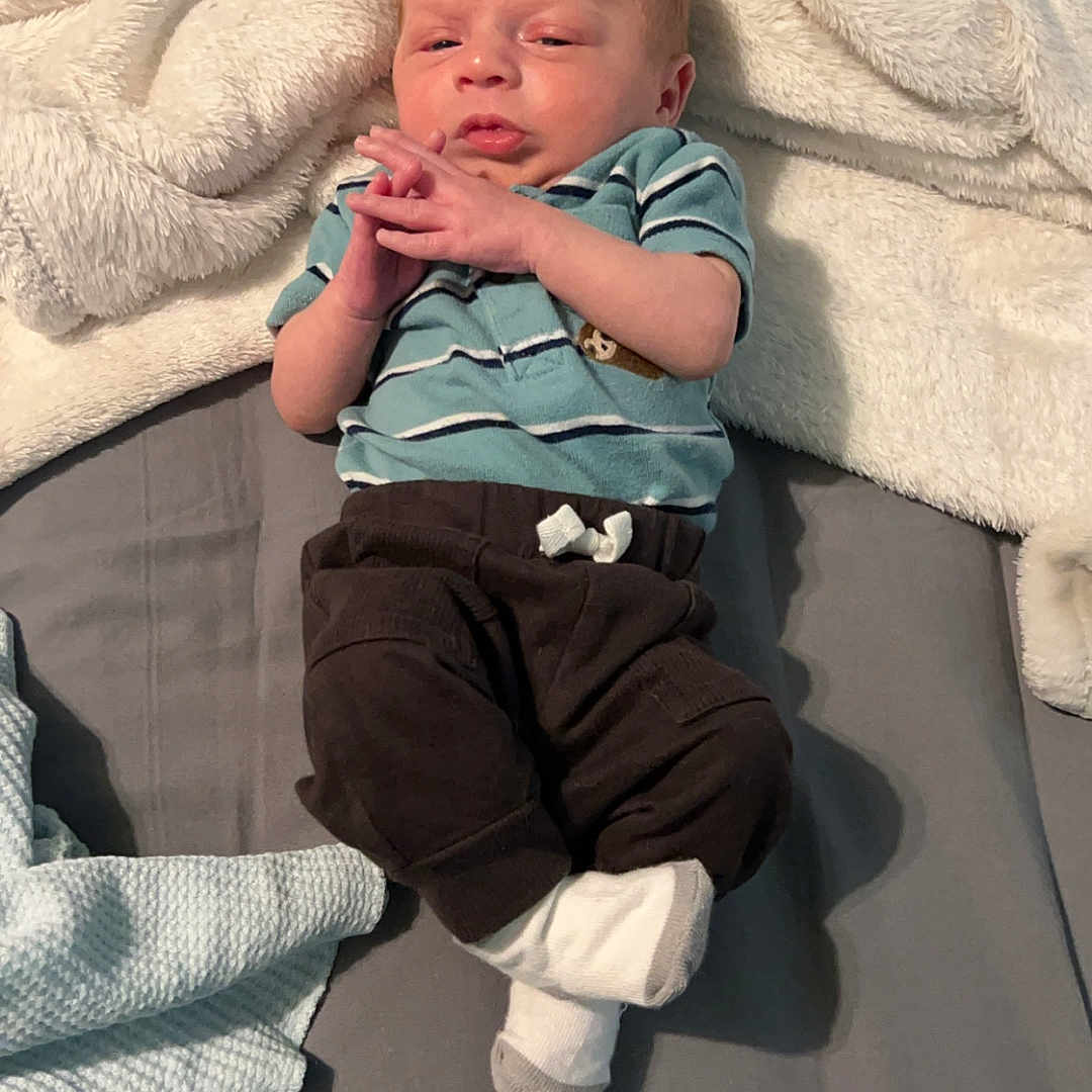 Paul-Brian joined the competition — help win amazing prizes! baby, bed, blanket, bodypart, clothing, couch, face, finger, furniture, glove, hand, head, newborn, pants, person, photography, portrait, shorts, sitting, sleeping