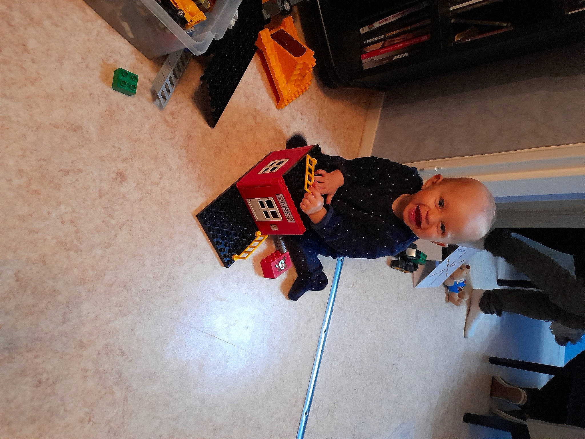 Maïwey participe au concours pour gagner de l'argent avec cette photo : baby, baby_products, baby_toddler_clothing, child, floor, flooring, fun, hardwood, person, play, room, shelf, sitting, toddler, wood