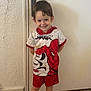 boy, casual, child, clothing, cute, door, fashion, floor, footwear, happy, indoor, person, portrait, red_shoes, shorts, smiling, standing, superhero_costume, tshirt, wall