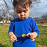 blue_shirt, boy, car, child, dandelion, eyelashes, fence, flower, grass, hair, hands, neighborhood, outdoor, portrait, shadow, sky, stick, sunlight, toddler, trees