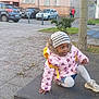 child, outdoor, jacket, hat, platform, tree, urban, building, car, pavement, curious, playful, person, winter_clothing, yellow_backpack, sneakers, nature, sidewalk, parked_cars, daylight