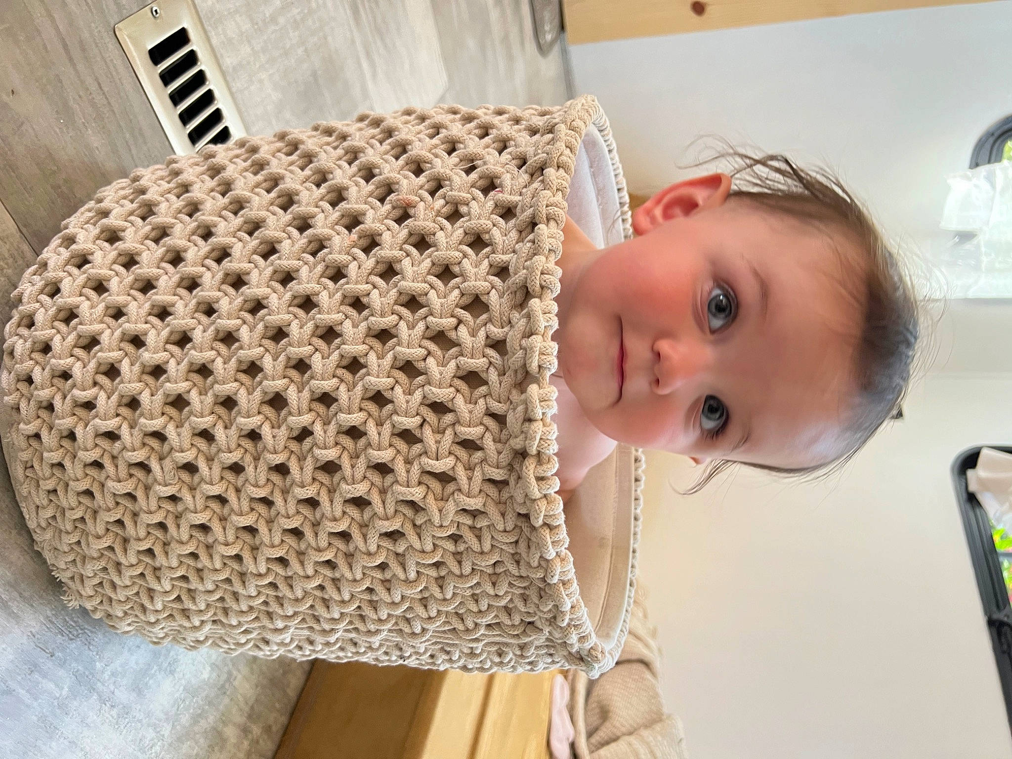 Ellie is registered to the contest to win money with this photo: art, baby, baby_products, baby_safety, baby_toddler_clothing, cheek, child, comfort, eyelash, flooring, fun, nose, pattern, person, room, smile, toddler, wicker, wood
