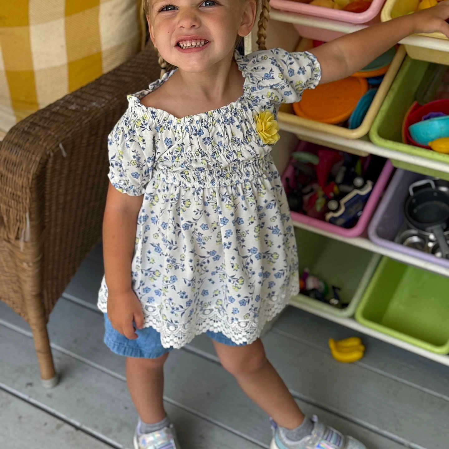 Naomi joined the competition — help win amazing prizes! braids, casual_clothing, child, childhood, colorful, cute, floral_top, girl, happy, indoor, play_food, playtime, portrait, posing, shorts, smile, sneakers, toy_bins, wicker_chair, wooden_floor
