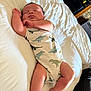 Hunter Dominic Russo joined the competition — help win amazing prizes! baby, newborn, sleeping, infant, bed, onesie, dinosaur_pattern, clothing, skin, limbs, peaceful, cute, indoors, soft_light, white_bed, person, relaxing, resting, child, portrait
