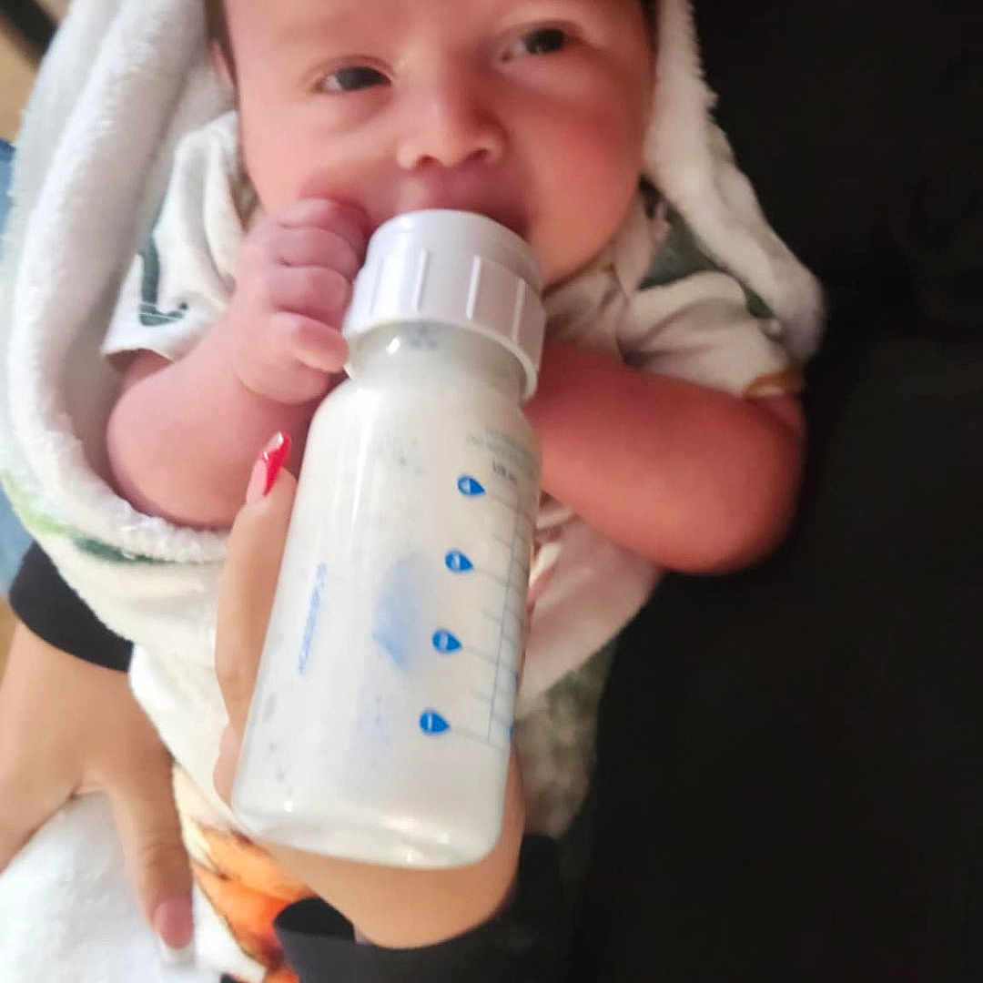 Hunter Dominic Russo is registered to the contest to win money with this photo: baby, bottle, caring, child, closeup, comfort, cute, feeding, feeding_time, hand, indoor, infant, milk, newborn, nursing, person, soft, towel, warm, wrapped