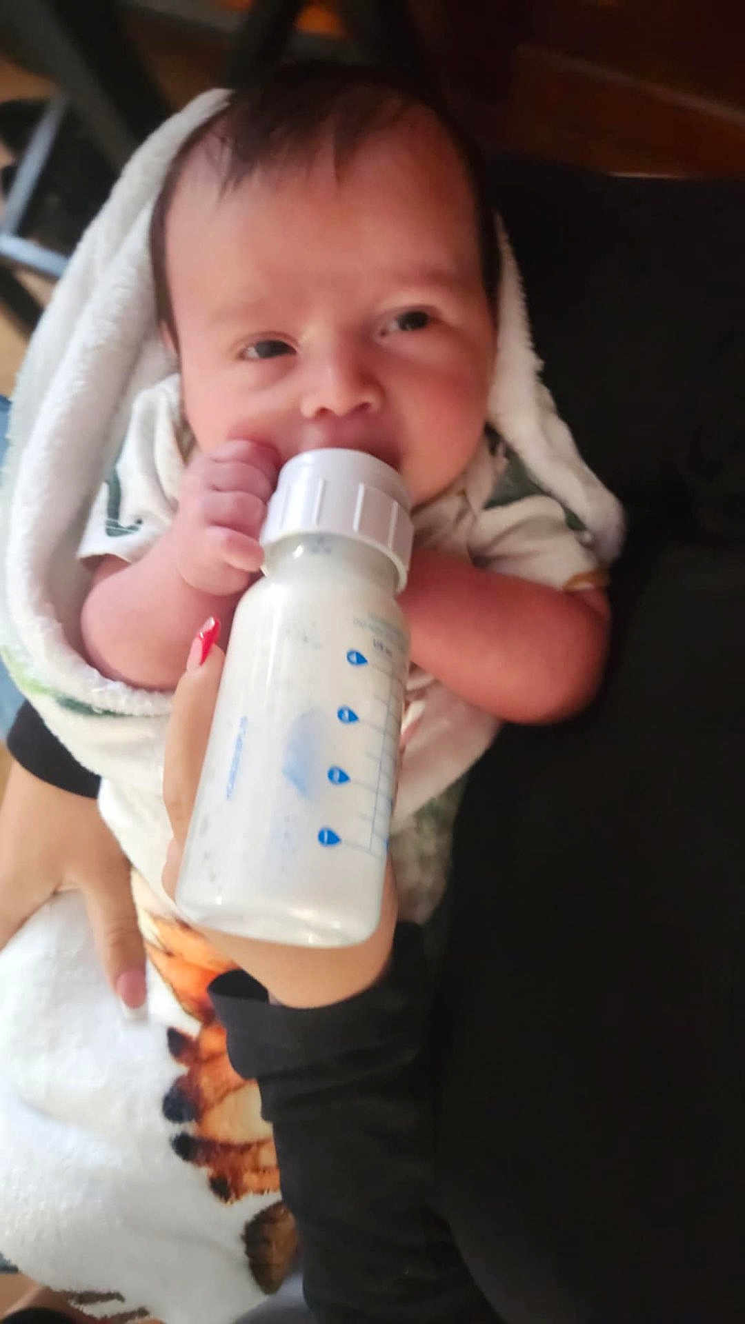 Hunter Dominic Russo is registered to the contest to win money with this photo: baby, bottle, feeding, hand, towel, milk, infant, closeup, person, nursing, soft, warm, indoor, cute, child, newborn, caring, comfort, feeding_time, wrapped