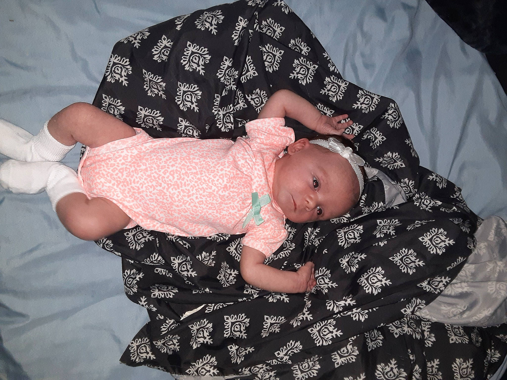 Kyleigh is registered to the contest to win money with this photo: arm, baby, baby_products, baby_toddler_clothing, black, child, comfort, facial_expression, finger, flash_photography, gesture, hand, head, human_body, leg, pattern, person, product, sitting, sleeve