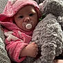 baby, pacifier, pink_hood, stuffed_animal, elephant_toy, blanket, knitted_blanket, towel, infant, cute, soft_texture, child, indoor, cozy, portrait, closeup, hand, wrapped, warm, sleepwear
