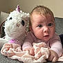 baby, blanket, child, clothing, couch, cute, expression, face, furniture, gray, hand, home, indoor, infant, person, pink, portrait, soft_toy, unicorn_plush, white
