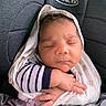 baby, sleeping, car_seat, blanket, infant, peaceful, wrapped, child, cute, soft, curly_hair, clothing, newborn, resting, young, toddler, indoors, seat, safety, portrait