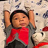 Rakai joined the competition — help win amazing prizes! baby, infant, mittens, beanie, plush_toy, panda, blanket, clothing, red, grey, cute, lying_down, arms_up, smiling, indoors, soft_toy, child, portrait, cozy, casual