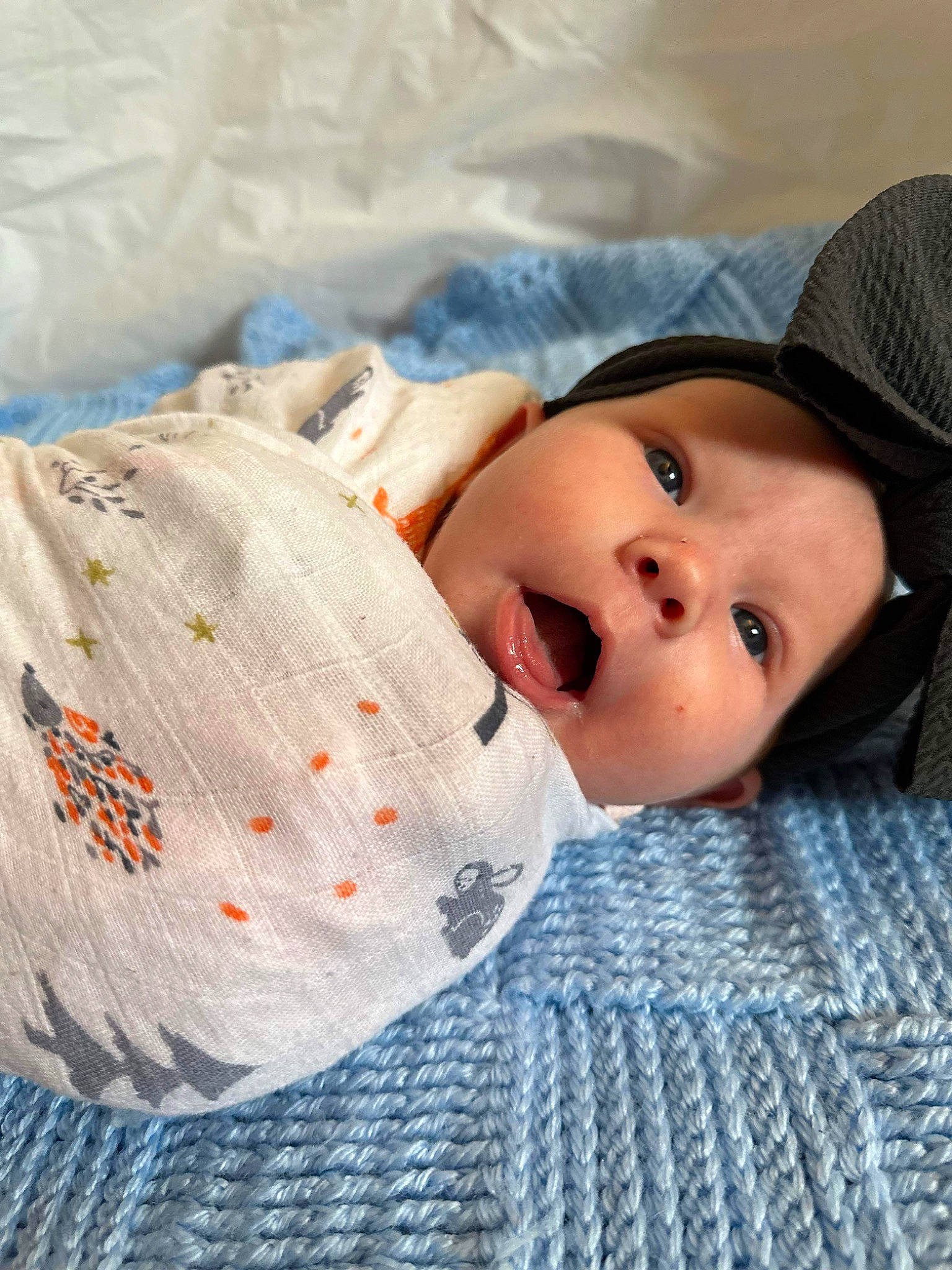 Roxie is registered to the contest to win money with this photo: baby, baby_toddler_clothing, child, comfort, eyelash, hat, headwear, linens, pattern, person, sleeve, textile, toddler, wool, woven_fabric
