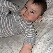 Eli joined the competition — help win amazing prizes! baby, child, infant, bed, bedding, pajamas, striped_clothing, hand, face, pacifier, lying_down, indoor, sleepwear, young_child, expression, skin, hair, cute, person, blanket