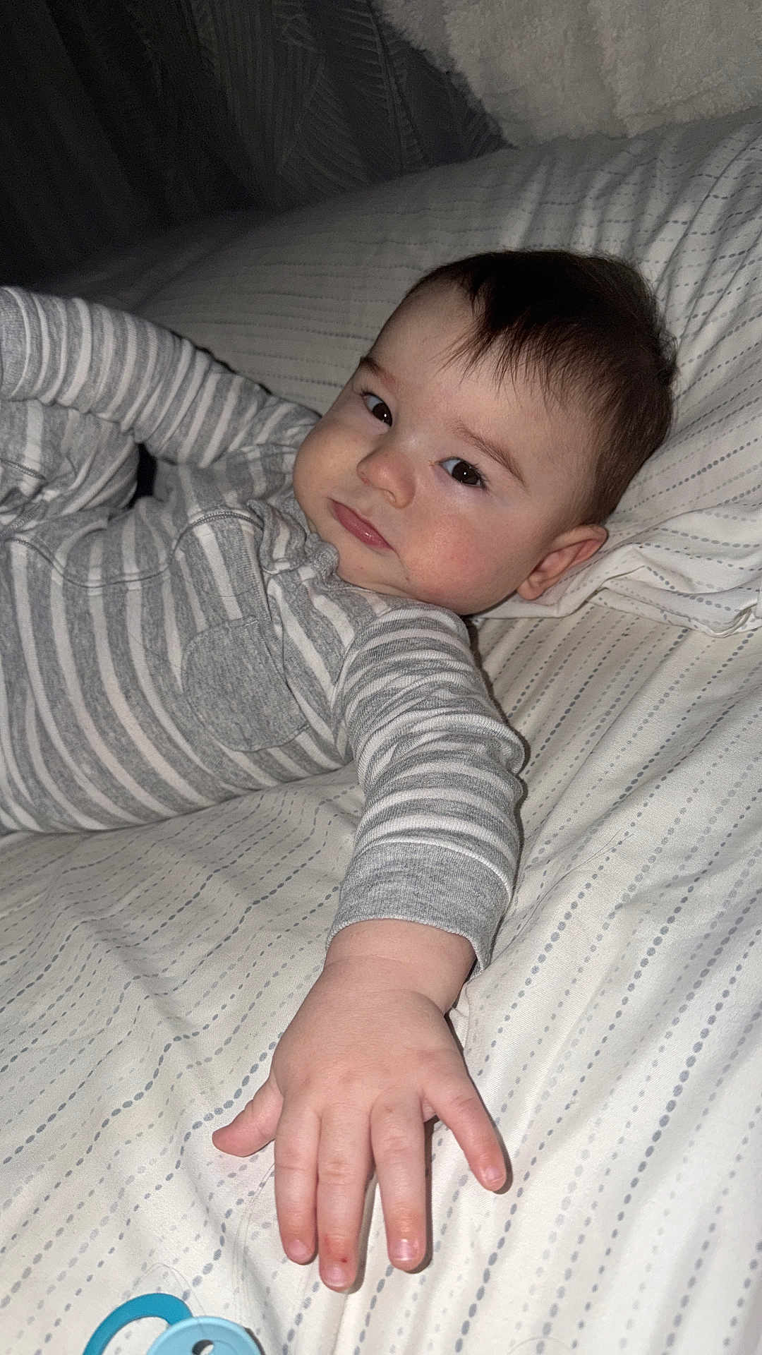 Eli joined the competition — help win amazing prizes! baby, child, infant, bed, bedding, pajamas, striped_clothing, hand, face, pacifier, lying_down, indoor, sleepwear, young_child, expression, skin, hair, cute, person, blanket