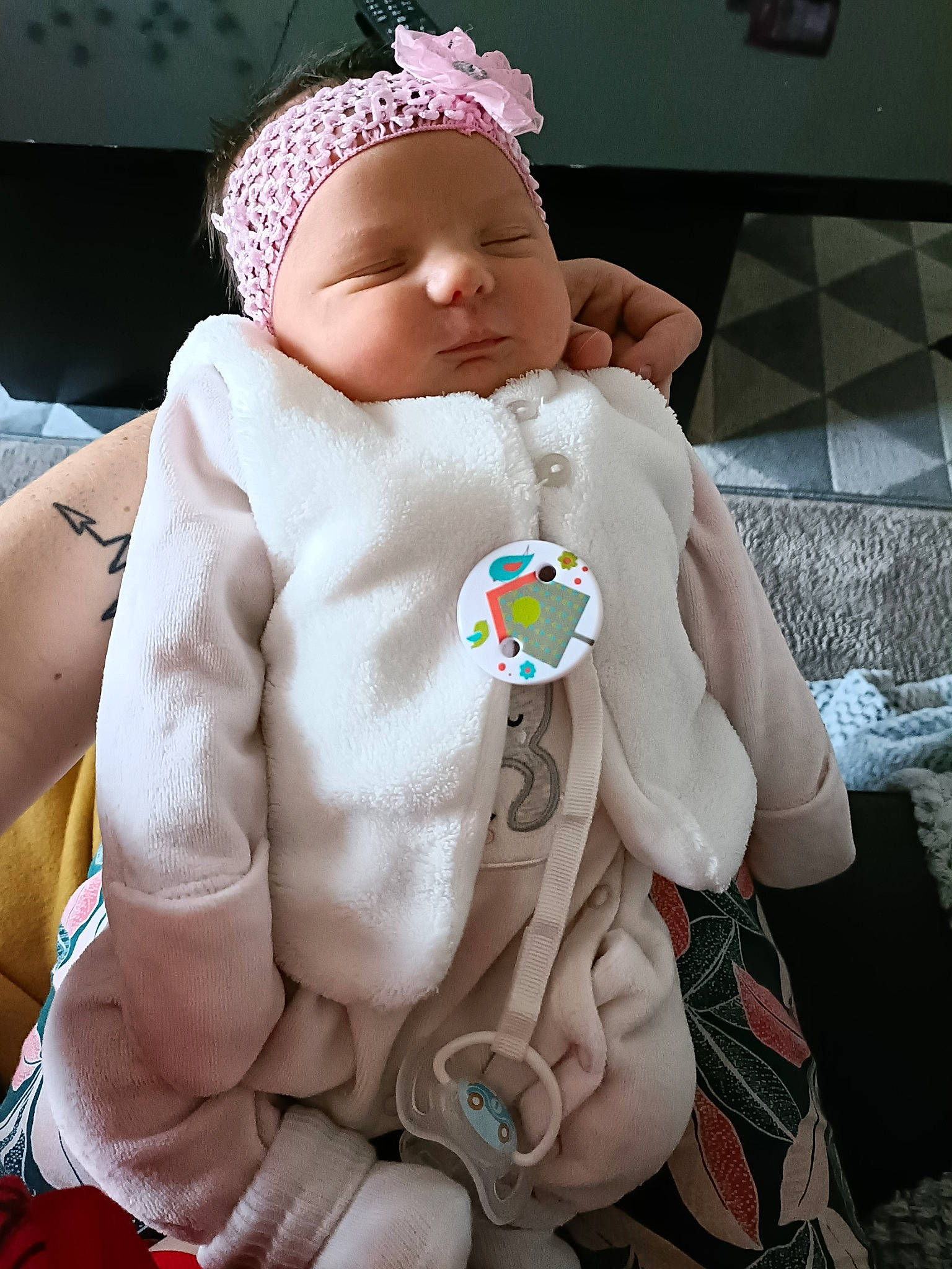Judith participe au concours pour gagner de l'argent avec cette photo : baby, baby_products, baby_sleeping, baby_toddler_clothing, cap, cheek, child, collar, comfort, fashion_accessory, gesture, headgear, headwear, linens, person, sitting, skin, sleeve, textile, thumb