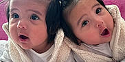 Ariel And Mafia is registered to the contest to win money with this photo: baby, infant, toddler, cute, child, pigtails, white_clothing, fluffy_vest, blanket, bedroom, pink_background, wide_eyes, surprised_expression, indoor, portrait, two_children, closeup, soft_light, adorable, cuteness