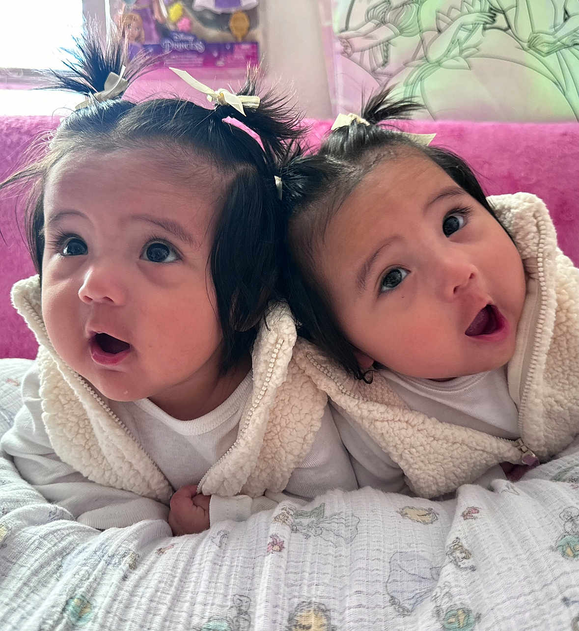 Ariel And Mafia is registered to the contest to win money with this photo: baby, infant, toddler, cute, child, pigtails, white_clothing, fluffy_vest, blanket, bedroom, pink_background, wide_eyes, surprised_expression, indoor, portrait, two_children, closeup, soft_light, adorable, cuteness