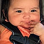 Ariel And Mafia is registered to the contest to win money with this photo: baby, child, pigtails, car_seat, seatbelt, orange_clothing, cute, smiling, finger_in_mouth, face, hair, infant, straps, safety, portrait, indoors, closeup, adorable, young_child, person