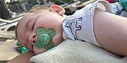 Tiziano participe au concours pour gagner de l'argent avec cette photo : arm, baby, blanket, child, closeup, clothing, comfort, daylight, face, infant, nature, outdoor, pacifier, peaceful, person, portrait, relaxation, rest, sleeping, soft