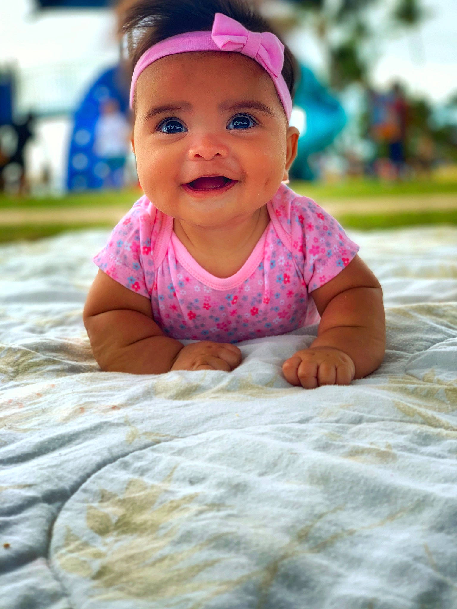 Kami is registered to the contest to win money with this photo: baby, baby_toddler_clothing, cheek, child, face, head, headgear, person, pink, play, skin, smile, toddler, tummy_time