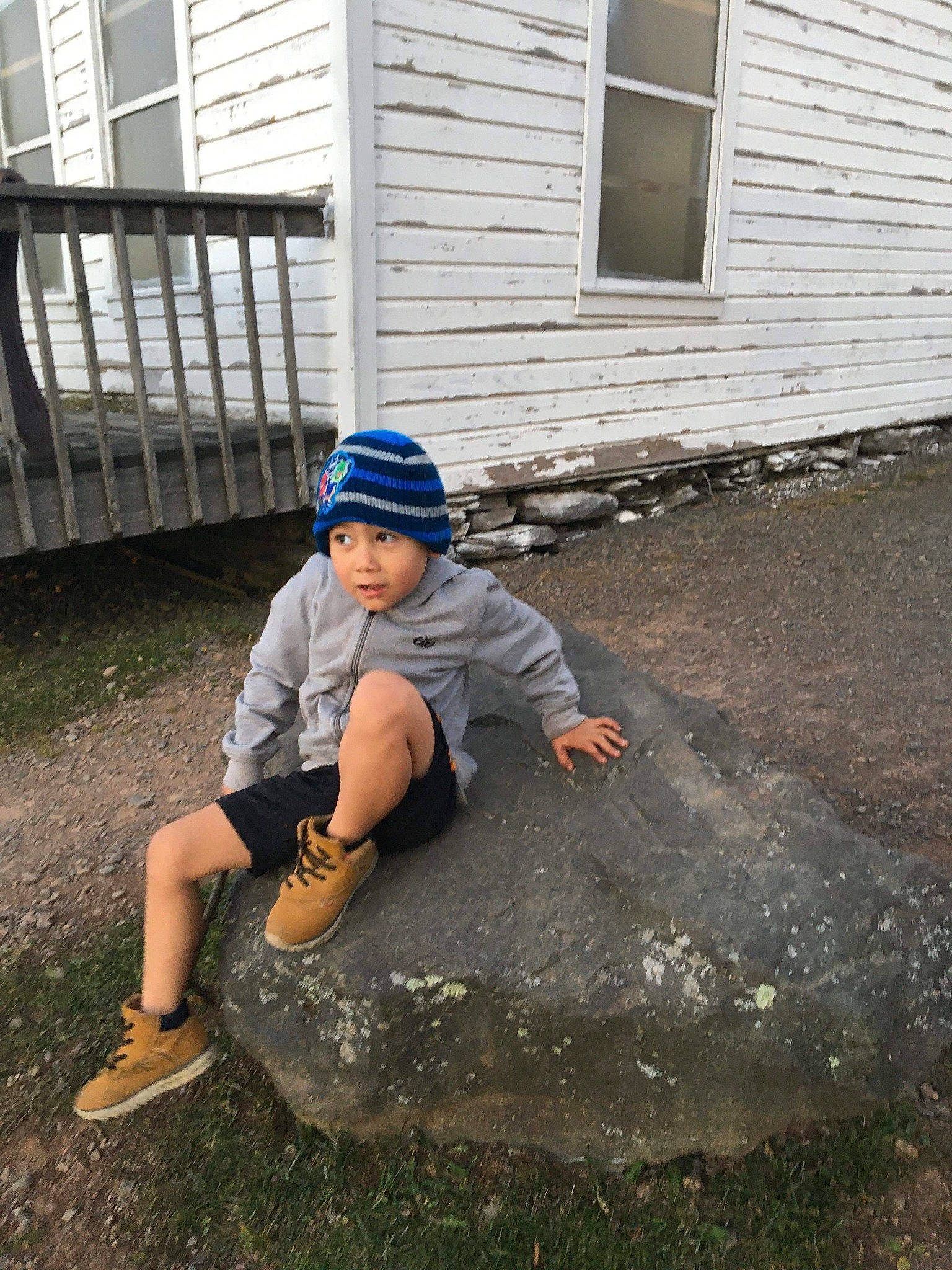 Enrique is registered to the contest to win money with this photo: child, concrete, headwear, person, play, rock, sitting, vacation