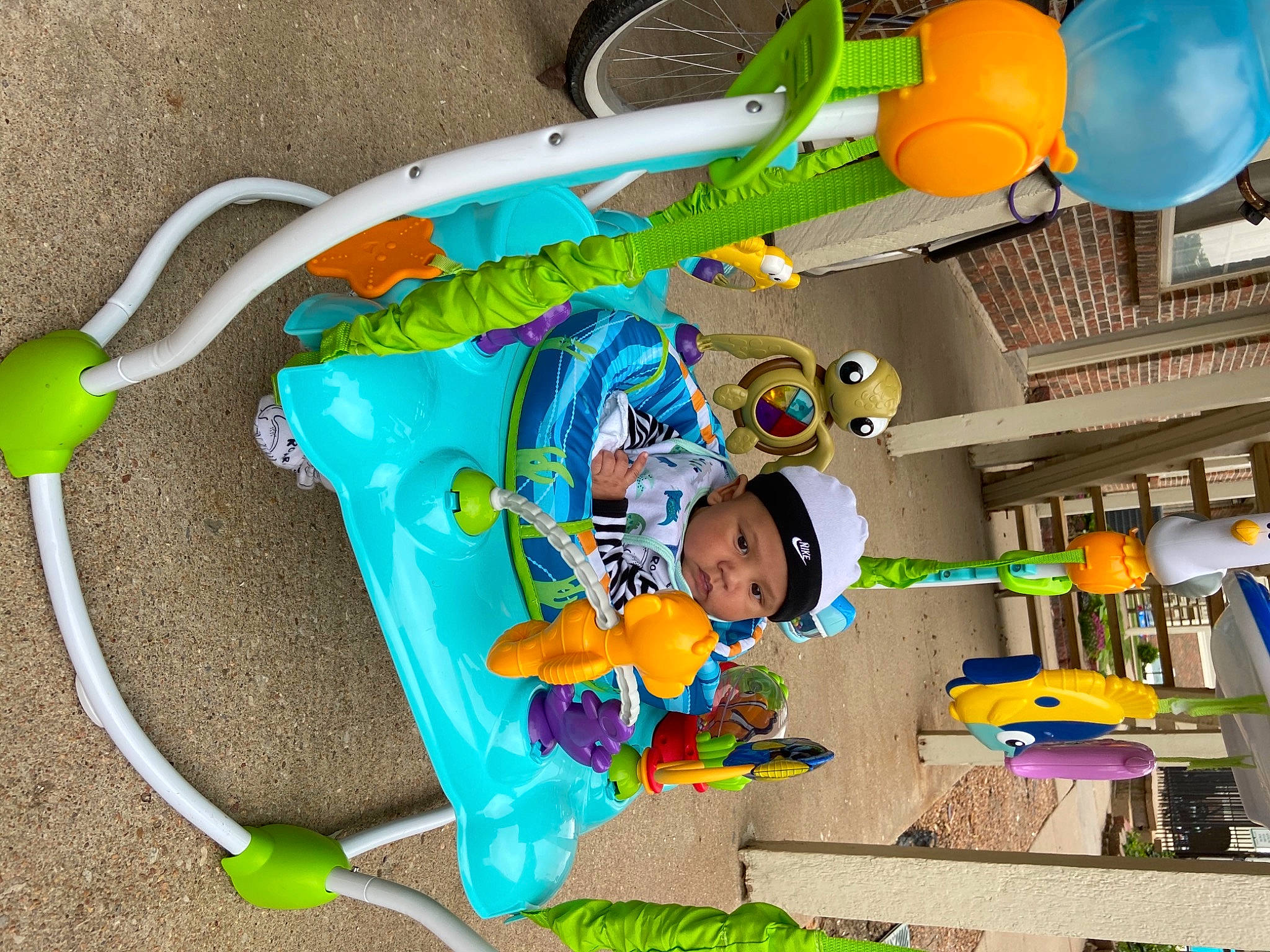 Marcel is registered to the contest to win money with this photo: art, baby, baby_products, baby_toddler_clothing, baby_toys, building, child, fashion_accessory, fun, green, headwear, kindergarten, party_supply, person, plastic, play, room, toddler, toy, toy_vehicle