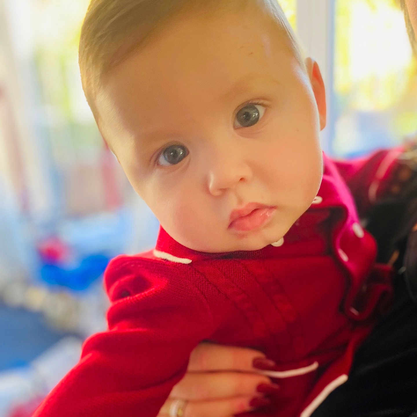 Rixon joined the competition — help win amazing prizes! baby, blue_eyes, child, closeup, cute, expression, face, hand, holding, human, indoor, infant, person, portrait, red_clothing, skin, sleeve, soft_focus, warm_light, young