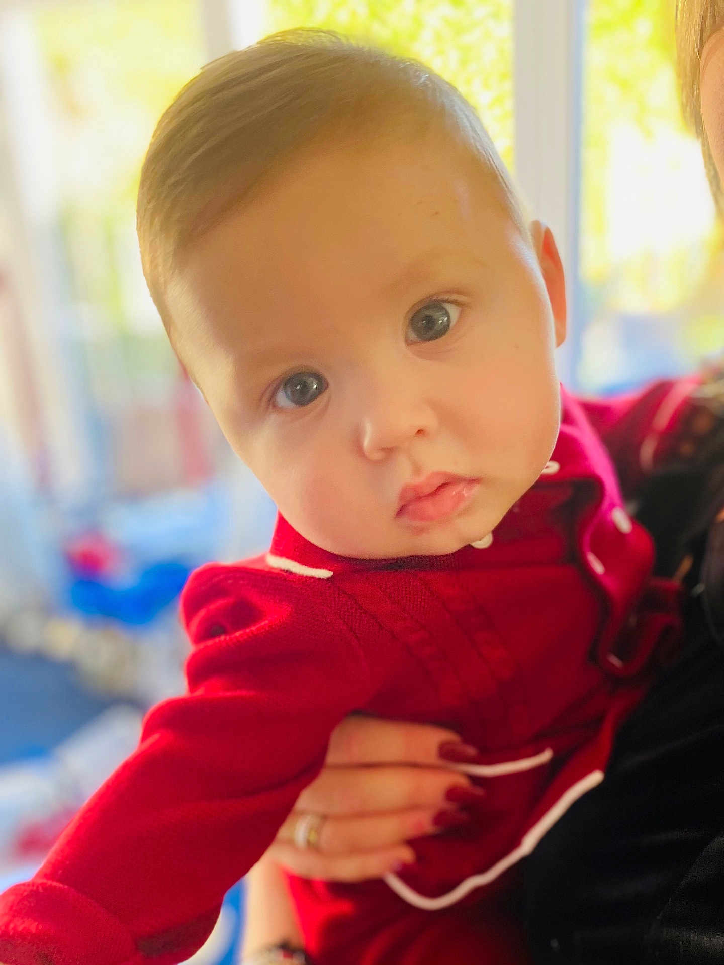 Rixon joined the competition — help win amazing prizes! baby, blue_eyes, child, closeup, cute, expression, face, hand, holding, human, indoor, infant, person, portrait, red_clothing, skin, sleeve, soft_focus, warm_light, young