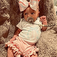 Paislee joined the competition — help win amazing prizes! baby, infant, pacifier, bow, pink, clothing, blanket, texture, cute, child, adorable, frills, soft, sitting, comfort, indoor, portrait, young, person, babywear