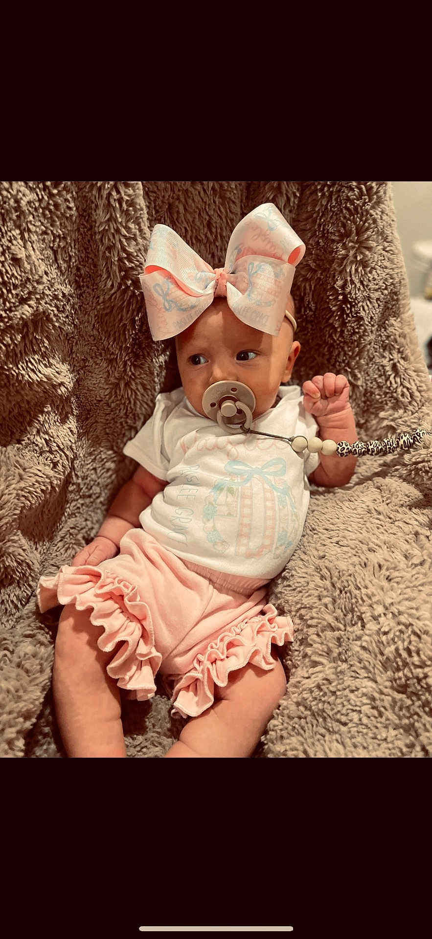 Paislee joined the competition — help win amazing prizes! baby, infant, pacifier, bow, pink, clothing, blanket, texture, cute, child, adorable, frills, soft, sitting, comfort, indoor, portrait, young, person, babywear