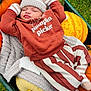 Archie joined the competition — help win amazing prizes! baby, sleeping, pumpkin, blanket, autumn, cozy, hat, mittens, striped_pants, outdoor, grass, wheelbarrow, fall, cute, child, nature, orange, yellow, green, seasonal