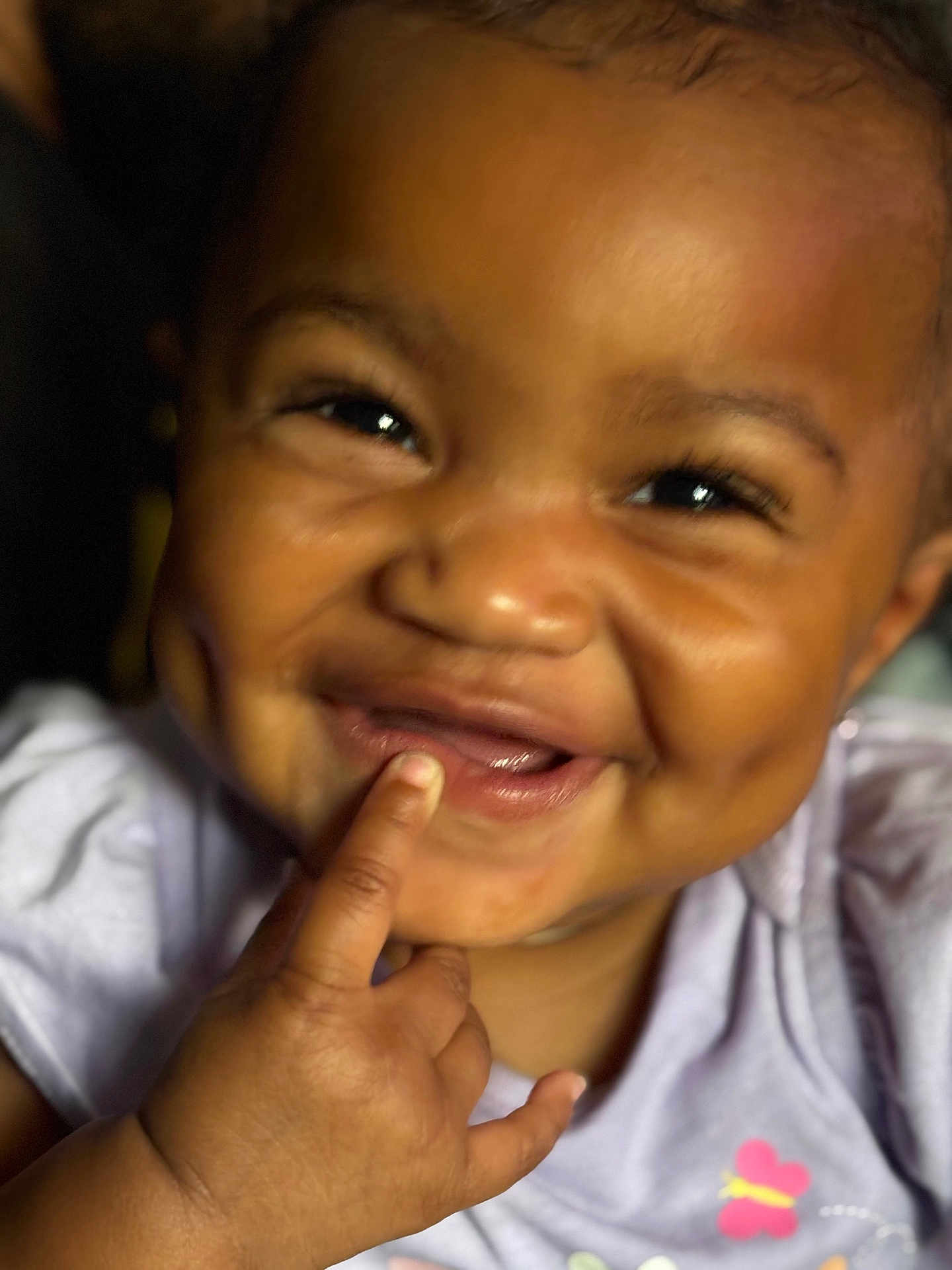 Heaven is registered to the contest to win money with this photo: baby, child, smile, finger, close_up, cute, happy, chubby_cheeks, purple_clothing, butterfly, face, skin, hand, person, infant, joy, expression, portrait, playful, young