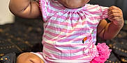 Heaven is registered to the contest to win money with this photo: baby, child, sunglasses, pink, striped_clothing, dimples, smiling, sitting, barefoot, indoors, romper, cute, portrait, young_child, happy, fashion, accessory, black_blanket, pattern, closeup