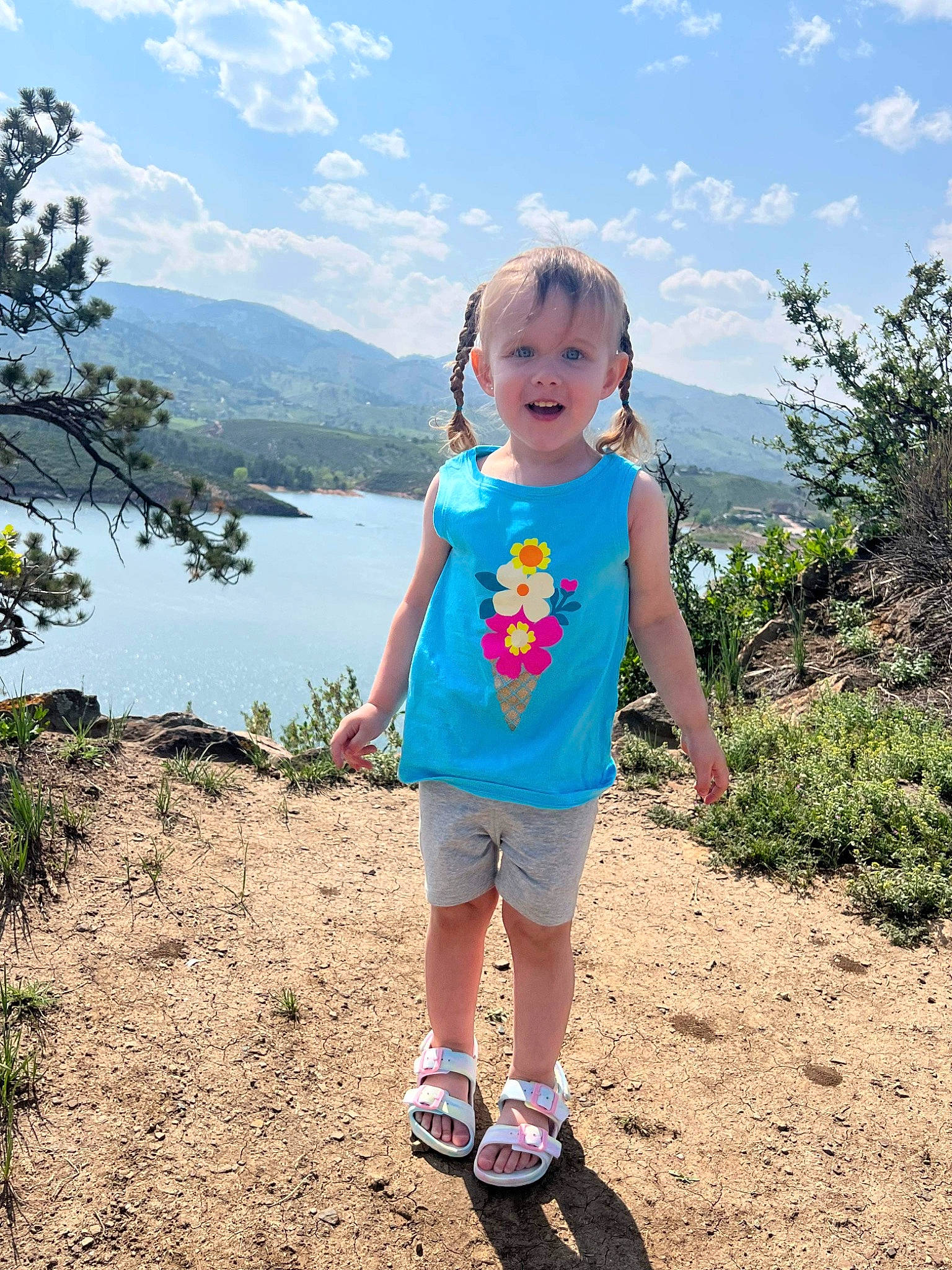 Thalia is registered to the contest to win money with this photo: azure, baby_toddler_clothing, cloud, electric_blue, fun, grass, happy, lake, landscape, leisure, people_in_nature, person, pink, plant, recreation, sky, summer, toddler, travel, tree