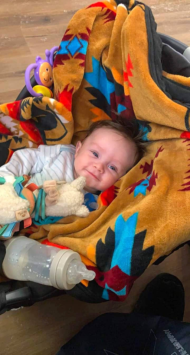 Colten is registered to the contest to win money with this photo: baby, baby_carriage, baby_products, baby_toddler_clothing, beauty, cheek, child, comfort, event, facial_expression, fun, happy, orange, person, room, skin, smile, textile, toddler, toy